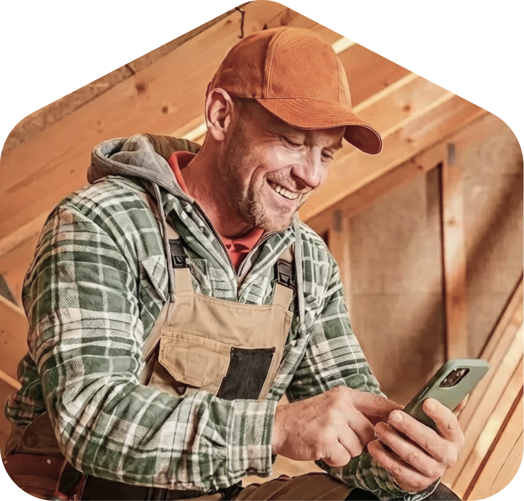 Contractor reviewing their phone on a job site