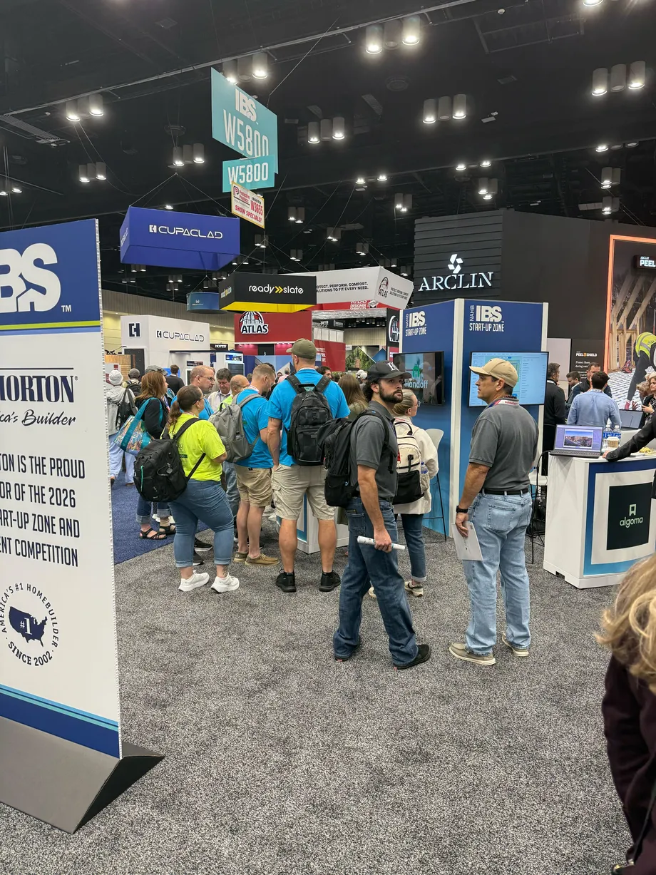 Attendees watching a Handoff demo screen on the show floor.