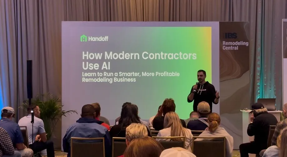 A Handoff speaker presenting How Modern Contractors Use AI to a seated audience.